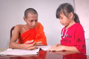 Một vị sư dạy chữ Khmer cho học trò trong dịp hè.