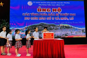 Học sinh Trường tiểu học Vĩnh Tuy ủng hộ đồng bào vùng lũ.