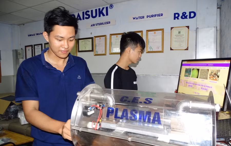 Sinh viên do PGS.TS Trần Ngọc Đảm hướng dẫn thực hành trên mô hình sử dụng công nghệ plasma. Ảnh: Hà An