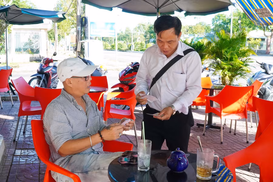 Thầy Tân tranh thủ thời gian rảnh bán vé số để có nguồn hỗ trợ học sinh, dân nghèo. Ảnh: Thành Thật
