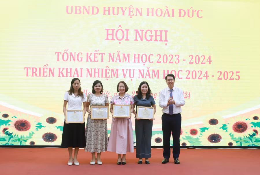 Các tập thể, cá nhân đạt thành tích trong việc triển khai học bạ số cấp Tiểu học được Chủ tịch UBND huyện Hoài Đức khen thưởng. Ảnh: Đình Tuệ.