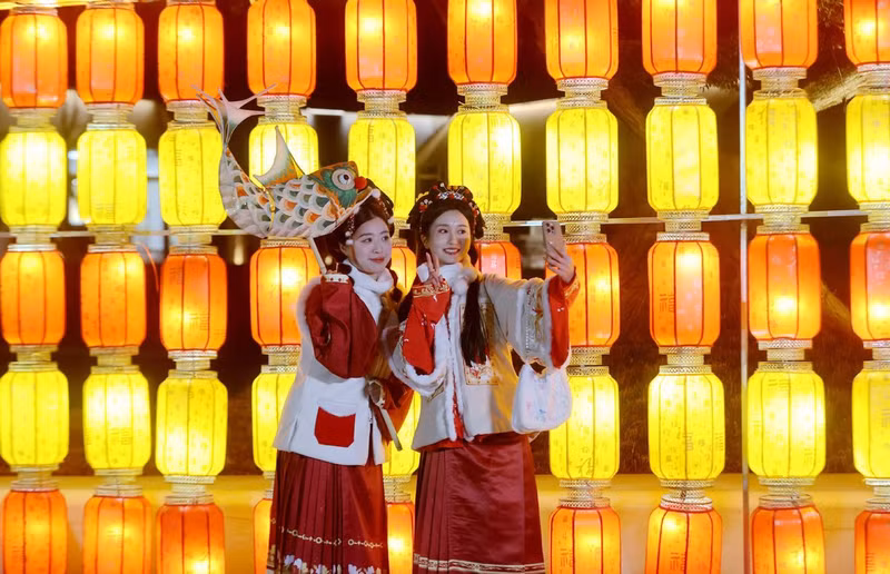 Hai du khách chụp ảnh với đèn lồng ở quận Deqing, Hồ Châu, tỉnh Chiết Giang, miền Đông Trung Quốc, ngày 7/2/2024. (Ảnh: Tân Hoa Xã) Đèn lồng đón năm con rồng rực rỡ khắp Trung Quốc