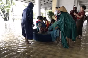 Lực lượng chức năng và giáo viên hỗ trợ đưa học sinh ra khỏi khu vực ngập ở Trường Mầm non Kỳ Thịnh (Phường Vũng Áng, Hà Tĩnh).