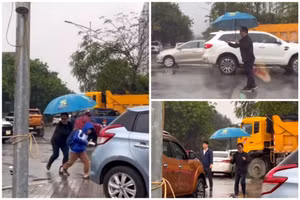 Hình ảnh thầy hiệu trưởng cầm ô che mưa, phân luồng giao thông đón học sinh ở Hà Tĩnh khiến cộng đồng mạng thán phục. (Ảnh cắt từ video)