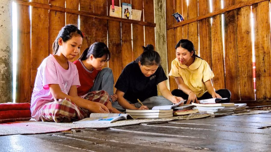 Các con, cháu của vợ chồng anh Pấng, chị Hồng soạn lại sách cũ để sử dụng cho năm học mới. 