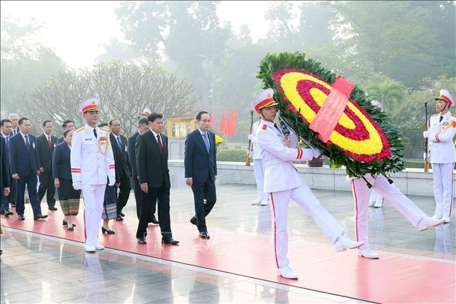 Tổng Bí thư, Chủ tịch nước Lào Thongloun Sisoulith và Phu nhân cùng Đoàn đại biểu cấp cao Đảng, Nhà nước Lào đến đặt vòng hoa tưởng niệm các Anh hùng liệt sĩ tại Đài tưởng niệm Bắc Sơn. Ảnh: An Đăng/TTXVN