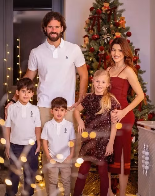Thủ môn Liverpool Alisson Becker xuất hiện trong chiếc áo polo trắng bên cạnh vợ và các con. 5.jpg