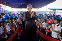 US President Bill Clinton surrounded by cheering schoolchildren during his historic visit to Ho Chi Minh City, Vietnam. Clinton