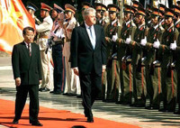 Vietnamese President Tran Duc Luong, left, and U.S. President Bill Clinton walk past Vietnamese soldiers during official welcoming ceremonies in Hanoi. Clinton
