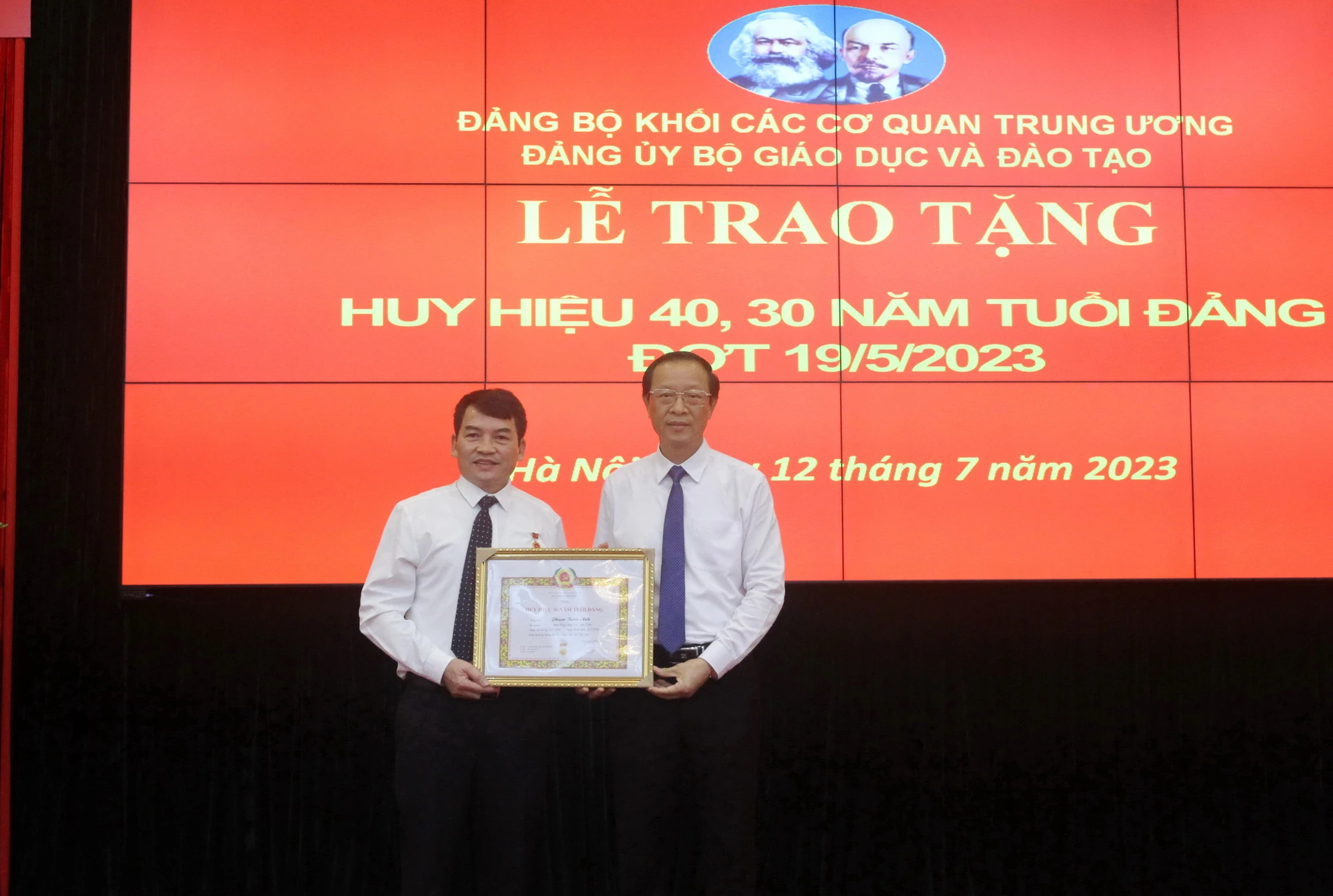 Thứ trưởng Phạm Ngọc Thưởng trao huy hiệu 30 năm tuổi đảng cho ông Phạm Tuấn Anh - Phó Cục trưởng Cục Nhà giáo và cán bộ quản lý giáo dục.