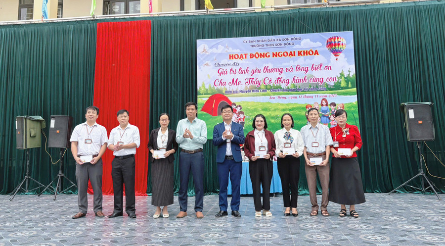 Lãnh đạo UBND xã Sơn Đông và lãnh đạo nhà trường khen thưởng giáo viên có thành tích.