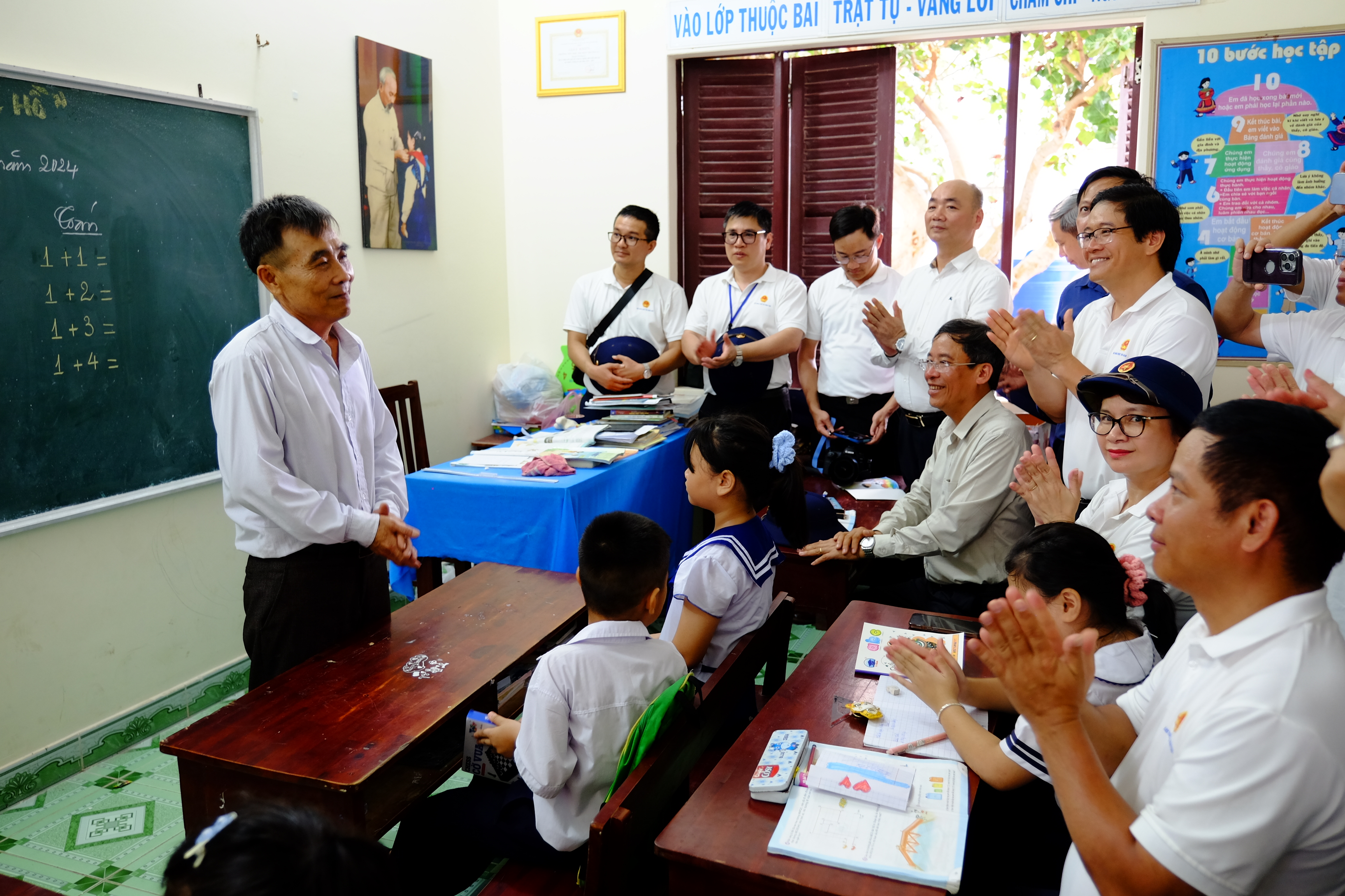 Thầy Lê Xuân Hạnh, giáo viên nhà trường, chia sẻ với đoàn công tác về những thuận lợi, khó khăn trong việc dạy và học tại Trường Sa. Sinh năm 1971, thầy vô cùng bất ngờ khi biết tin được cử ra đảo theo diện bổ sung vào tháng 9/2023. Trước đó, thầy đã đăng ký ra đảo dù biết là tuổi không còn trẻ. Trước khi ra đảo, thầy Hạnh dạy lớp 5 trường Tiểu học Cam Phước Tây 1 (Cam Lâm, Khánh Hòa). Thầy từng có 15 năm dạy học ở điểm trường vùng sâu vùng xa. Ra dạy học ở đảo, thầy bảo mình vừa là người thầy, vừa là người ông của đám trẻ nơi đây.