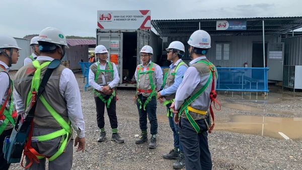 Ông Trần Đại Nghĩa (thứ 4, từ trái sang) - Tổng Giám đốc Tập đoàn Xây dựng Minh Đức cùng các kỹ sư đang trao đổi tại công trường. Ảnh: NVCC