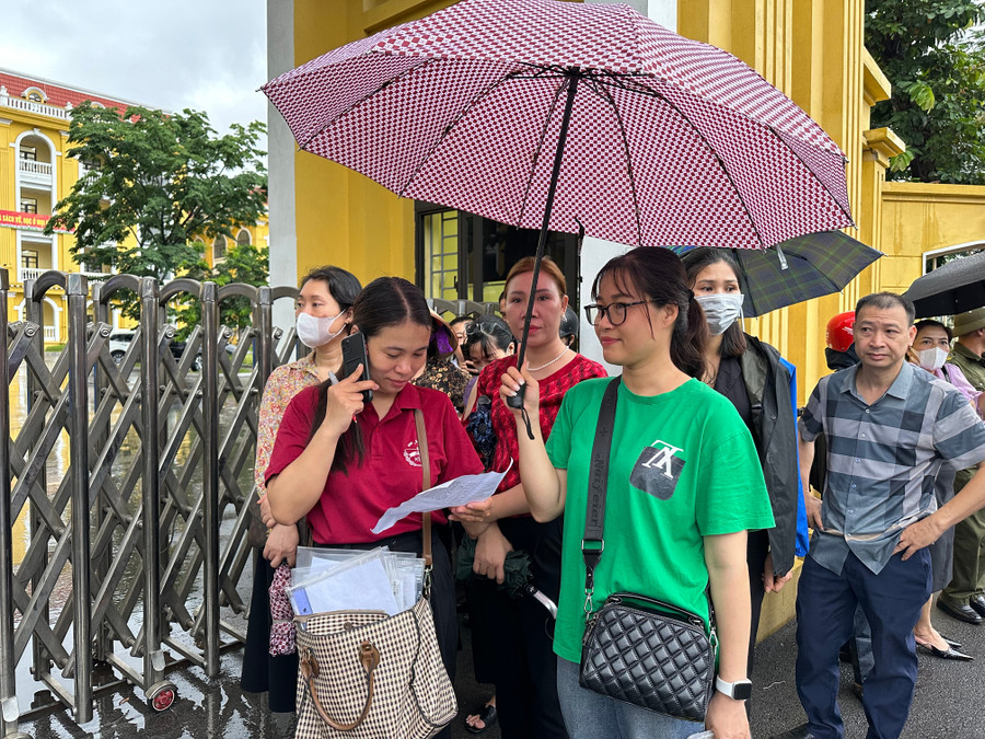 Cô giáo Lê Thị Thu (áo đỏ) liên tục gọi điện cho phụ huynh để xác nhận các em đã đến điểm thi chưa. img-9404.jpg