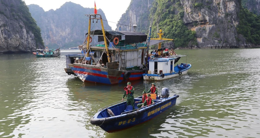 Cán bộ, chiến sĩ Bộ đội Biên phòng kêu gọi tàu thuyền vào nơi tránh trú bão số 3.