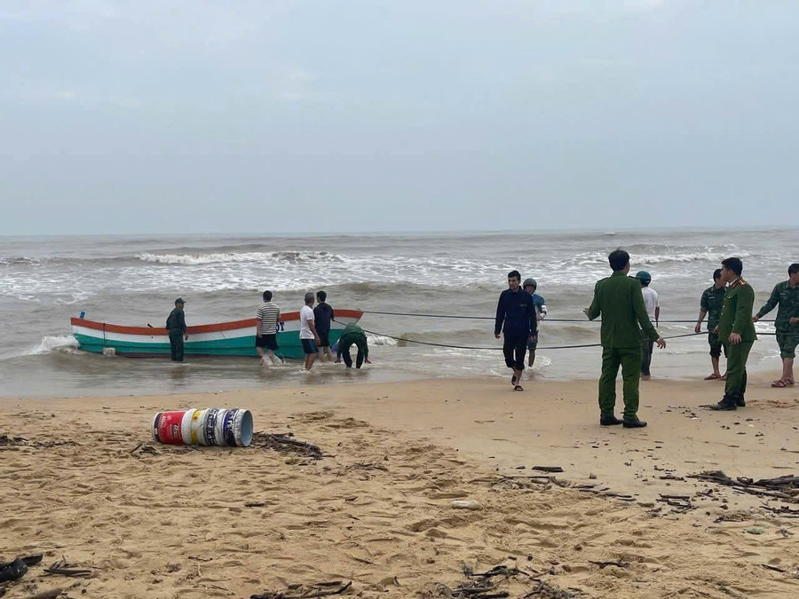 Các lực lượng chức năng kéo tàu cá vào bờ.