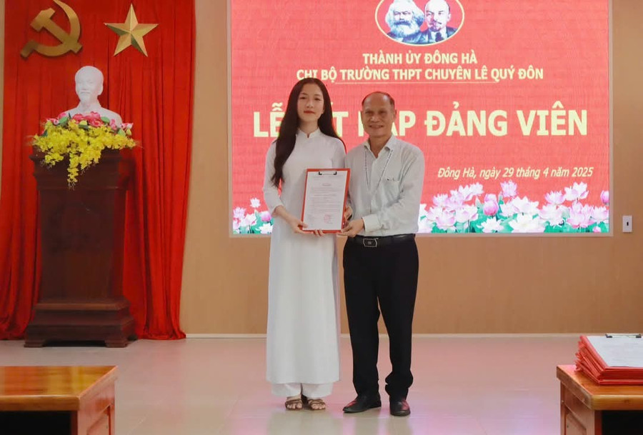 Nhà giáo ưu tú Nguyễn Hoài Nam, Bí thư Chi bộ Trường THPT chuyên Lê Quý Đôn trao quyết định kết nạp Đảng cho học sinh. 1000012461.jpg