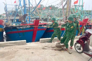 Bộ đội Biên phòng Nghệ An giúp ngư dân neo đậu tàu thuyền. (Ảnh: Anh Bách)