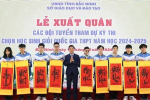 Phó Chủ tịch UBND tỉnh Bắc Ninh Lê Xuân Lợi trao tặng tranh chữ cho các em học sinh.