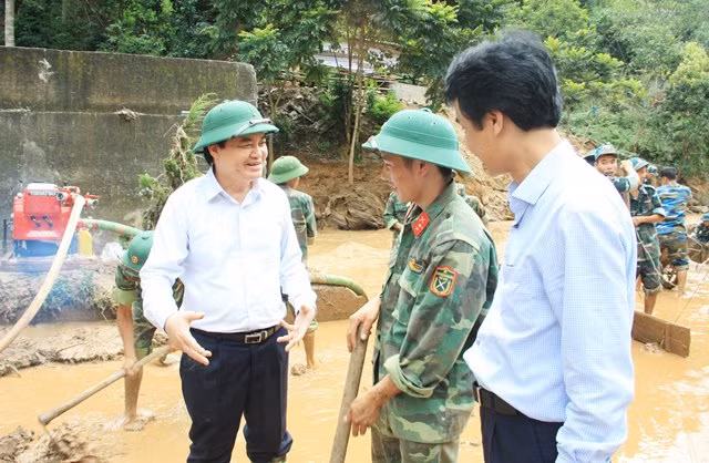 Bộ trưởng Bộ GD&ĐT Phùng Xuân Nhạ động viên các thầy cô Trường PTDTBT THCS Nà Ớt (Mai Châu, Sơn La) khắc phục hậu quả mưa lũ. Ảnh Sỹ Điền