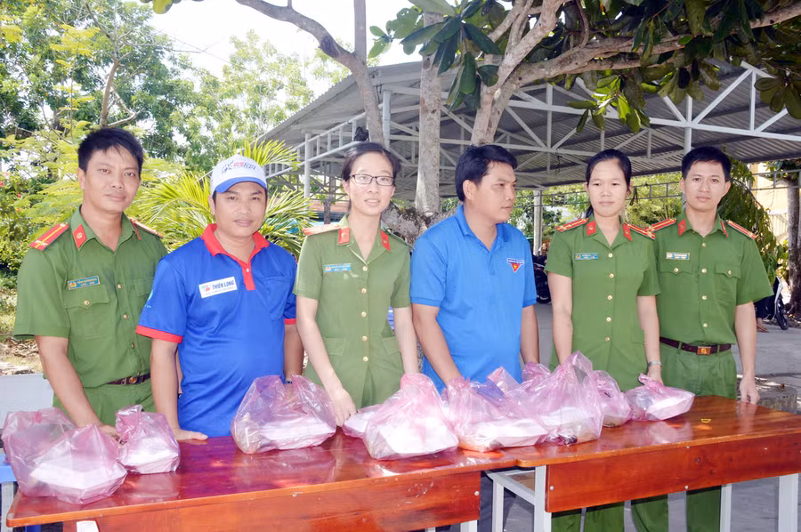 Chiến sĩ Công an và thanh niên tình nguyện cùng phát bữa cơm trưa cho sĩ tử
