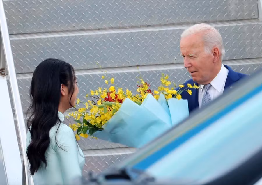 Giây phút đáng nhớ của nữ sinh Nguyễn Trà My khi được tặng hoa cho Tổng thống Mỹ Joe Biden khi đặt chân xuống sân bay Nội Bài, chiều 10/9. Ảnh: TTXVN