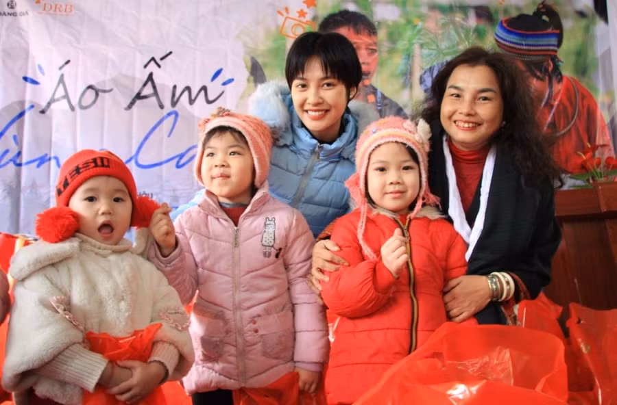 Nhà báo Phạm Thị Bằng Giang - Chánh văn phòng Hội Thông tin Khoa học và Công nghệ Việt Nam (ngoài cùng bên phải) và Hoa hậu trao quà và chụp ảnh lưu niệm cùng các cháu học sinh mầm non.