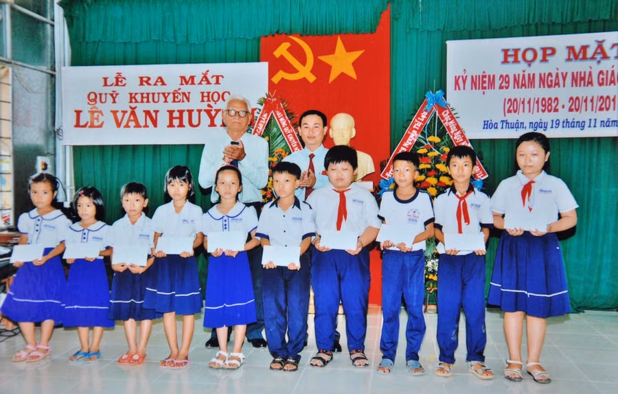 Đại diện Quỹ Khuyến học Lê Văn Huỳnh trao học bổng cho các em học sinh.