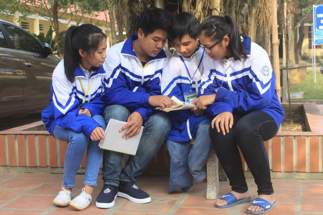 Ngô Minh Hiếu (thứ hai, từ trái sang) và người bạn khuyết tật Nguyễn Tất Minh (thứ 3, từ trái sang) cùng các bạn trong lớp đang tranh thủ thảo luận bài tập.