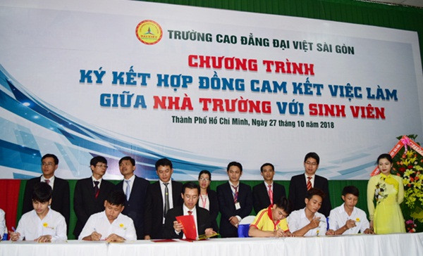 TS Lê Lâm (giữa) thực hiện ký hợp đồng cam kết việc làm với từng sinh viên