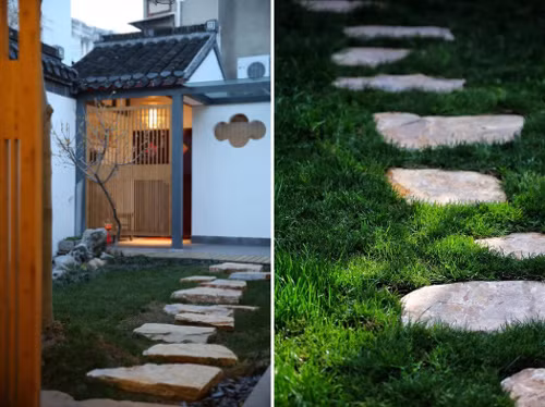 Lối dẫn vào nhà đi qua thảm cỏ xanh,lót đá.