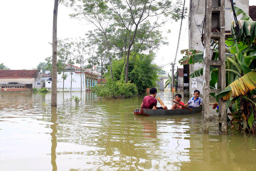 Trẻ em trong làng di chuyển bằng thuyền tới trường