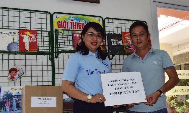 Cô Nguyễn Thị Kim Hương-Hiệu trưởng Trường Tiểu học Lạc Long Quân, Quận 11, TPHCM trao tặng 1.000 quyển tập cho đại diện Báo Giáo dục & Thời đại