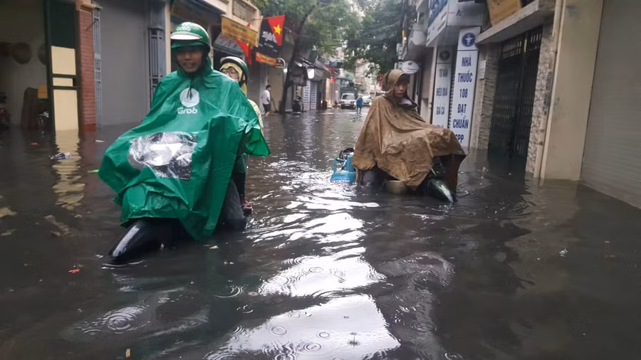 Hà Nội mưa lớn sáng 30/4, xe máy bơi trong biển nước