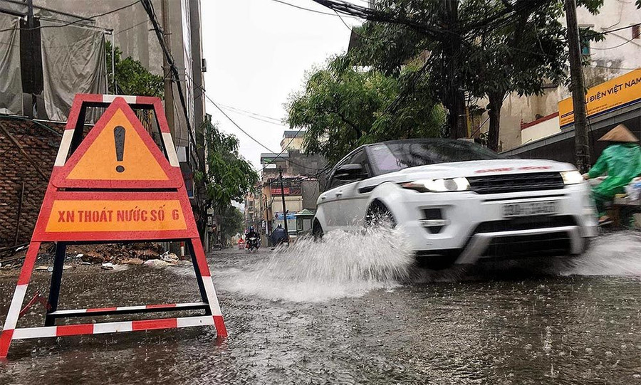 Hà Nội mưa lớn sáng 30/4, xe máy bơi trong biển nước