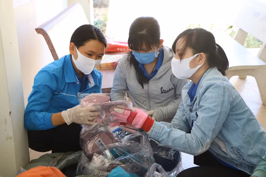 Các đoàn viên, thanh niên huyện Thuận Nam và xã Phước Nam chuẩn bị khẩu trang y tế để đi phát cho người dân thôn Văn Lâm 3. (Ảnh: Ý Thảo).