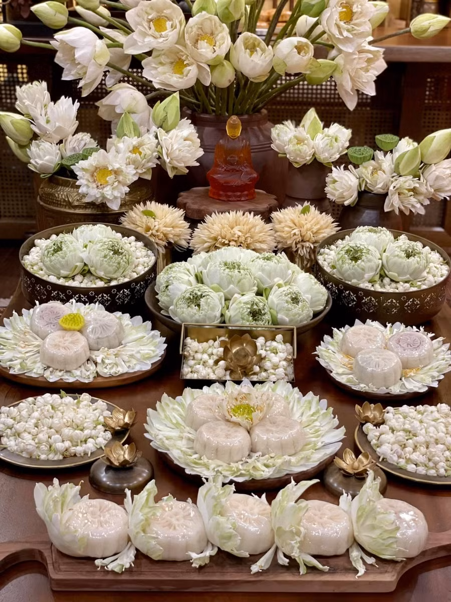 Lấy lớp cánh trong của hoa sen xếp vòng quanh đĩa rồi bày bánh dẻo lên.