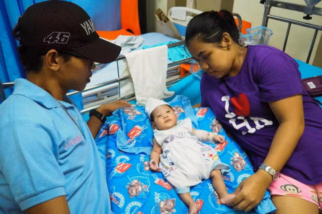 Nhel chụp ảnh cùng cha mẹ của em