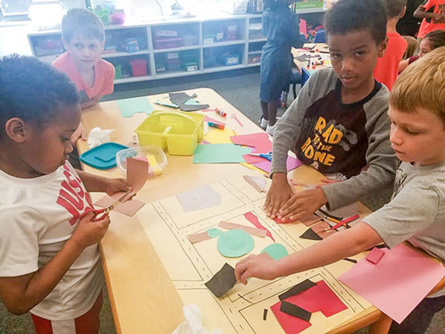 HS lớp Một làm việc theo nhóm để tạo ra một bức tranh ghép giấy màu mô tả sự liên kết cộng đồng