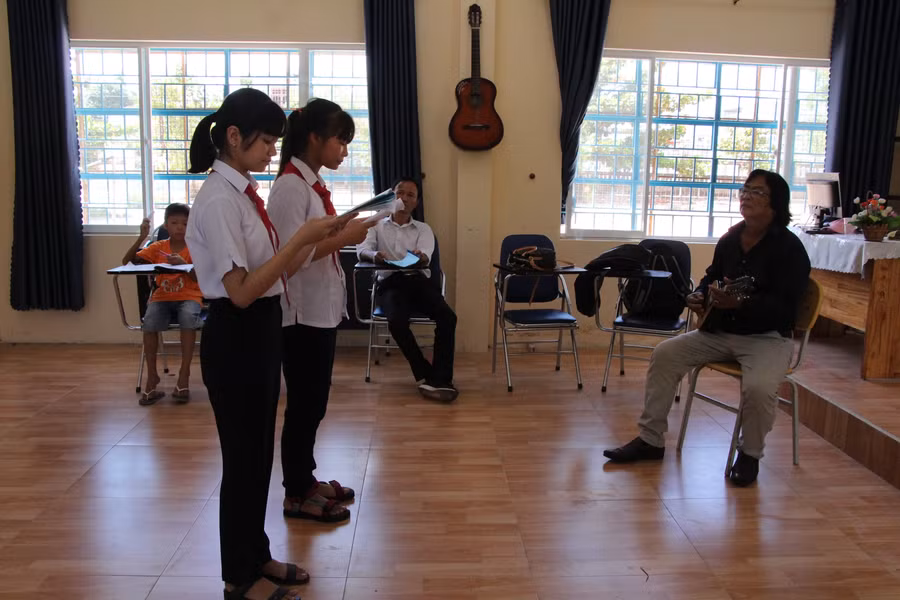 Nghệ nhân ưu tú Trịnh Công Sơn đang hướng dẫn các em HS tập một làn điệu bài chòi