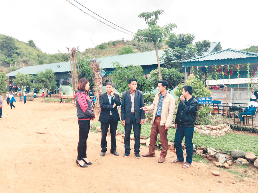 Thầy Đinh Quang Vinh (thứ hai từ phải sang) và các thầy cô giáo trong Ban Giám hiệu nhà trường đang giới thiệu với ông Lò Văn Phúi những dự định phát triển về cơ sở vật chất nhà trường thời gian tới
