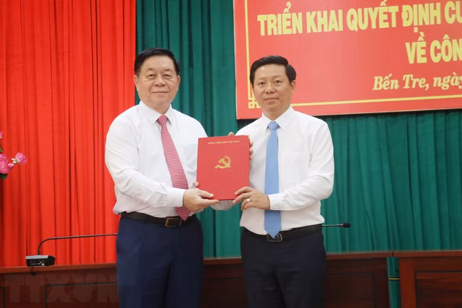 Trưởng Ban Tuyên giáo Trung ương Nguyễn Trọng Nghĩa (trái) trao Quyết định cho ông Trần Thanh Lâm. (Ảnh: Chương Đài/TTXVN)