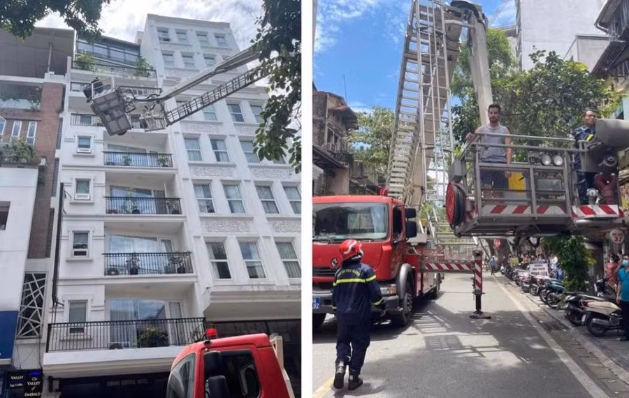 Lực lượng chức năng dùng xe thang đưa nhiều khách nước ngoài thoát khỏi đám cháy.