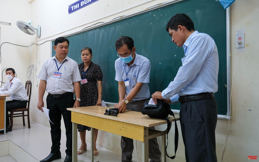 Trưởng điểm thi, thư ký và thanh tra thi đến phòng thi để tháo niêm phong camera và máy ghi âm, đảm bảo an ninh an toàn.