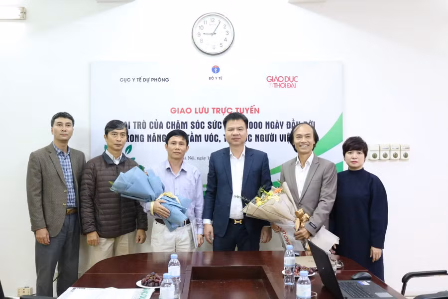 Tổng biên tập Báo GD&TĐ Triệu Ngọc Lâm (giữa) tặng hoa cho các khách mời tham gia cuộc giao lưu trực tuyến. 