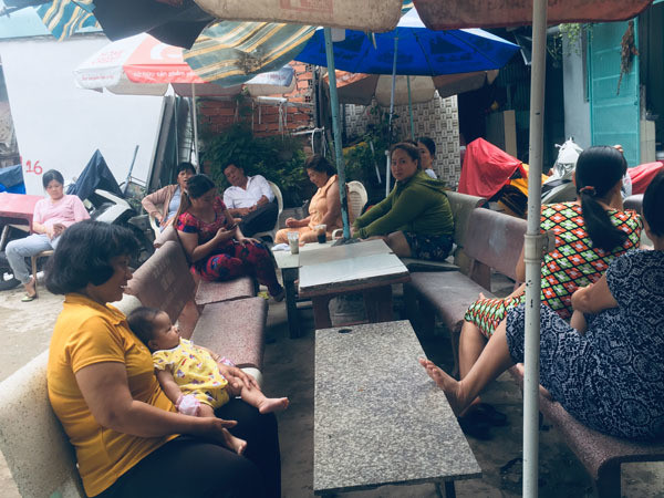 Hiện các ngôi mộ đã được dời đi, người dân trong xóm kê ghế đá ngồi nói chuyện với nhau. Ảnh. T.A. Xóm Gò Mả Sài Gòn: 3-4 ngôi mộ nằm trước cửa nhà