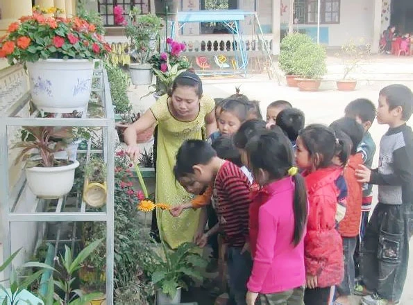 Cô và cháu Trường MN Châu Khê trong tiết học ngoài trời