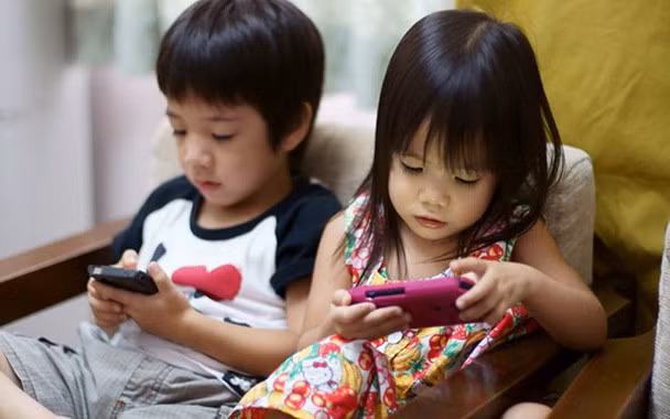 Trẻ mê điện thoại. 