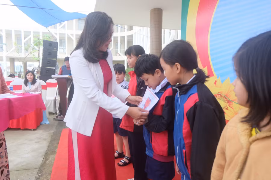 Trao học bổng “San sẻ yêu thương” cho các em học sinh.