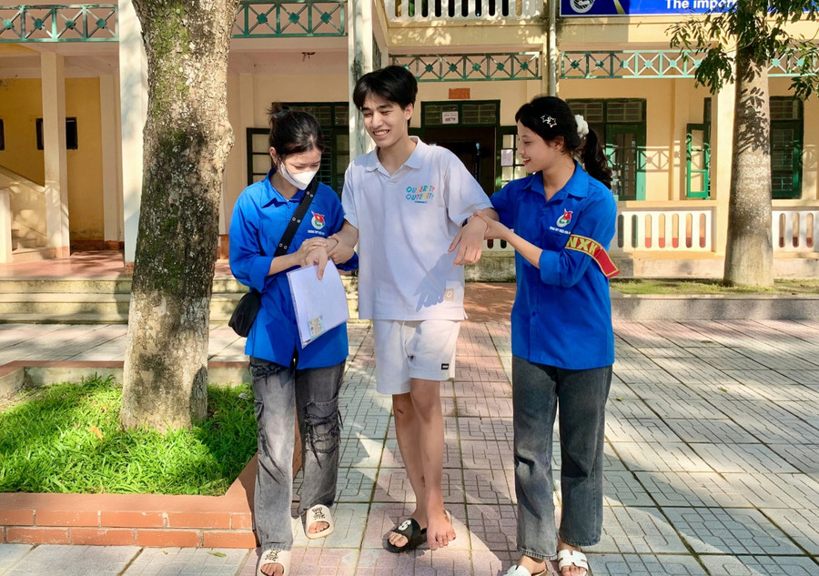 Khang (ở giữa) được đội tình nguyện tiếp sức mùa thi hỗ trợ vào phòng thi. Ảnh: Cẩm Vân. Khang (ở giữa) được đội tình nguyện tiếp sức mùa thi hỗ trợ vào phòng thi. Ảnh: Cẩm Vân.